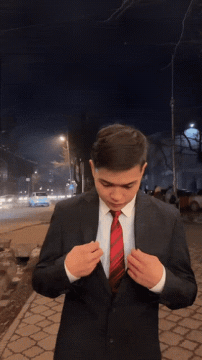 A Man In A Suit And Tie Is Blowing A Kiss At The Camera GIF