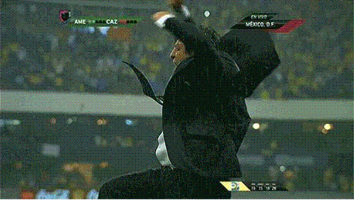 A Man In A Suit And Tie Is Celebrating In Front Of A Scoreboard That Says Ame Caz GIF