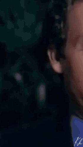 A Man In A Suit And Tie Is Clapping His Hands In A Close Up . GIF