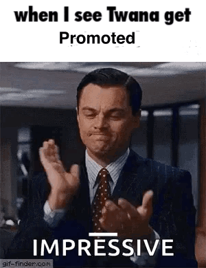 A Man In A Suit And Tie Is Clapping His Hands In A Gif . GIF