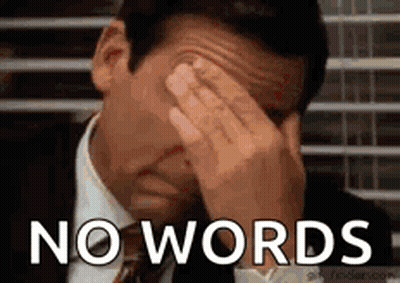 A Man In A Suit And Tie Is Covering His Face With His Hands And The Words `` No Words '' Are Behind Him . GIF