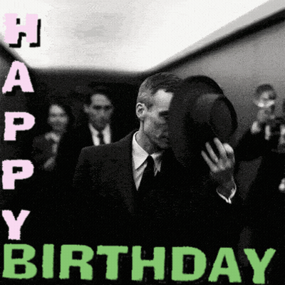 A Man In A Suit And Tie Is Covering His Face With His Hat And The Words Happy Birthday Are Above Him GIF