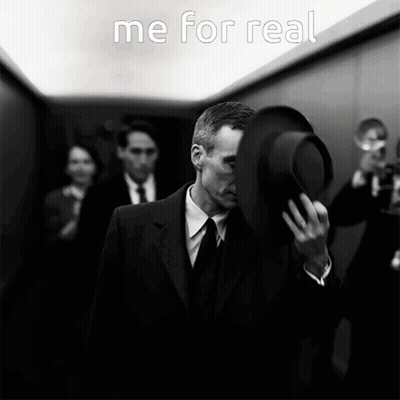 A Man In A Suit And Tie Is Covering His Face With His Hat And The Words " Me For Real " Are Above Him GIF