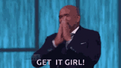 A Man In A Suit And Tie Is Covering His Mouth With His Hands And Says Get It Girl ! GIF