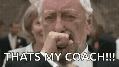 A Man In A Suit And Tie Is Crying And Covering His Mouth With His Fist . GIF