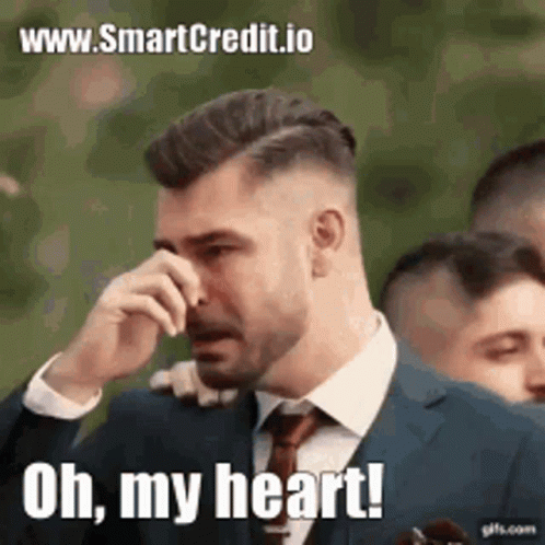 A Man In A Suit And Tie Is Crying And Saying `` Oh , My Heart '' . GIF