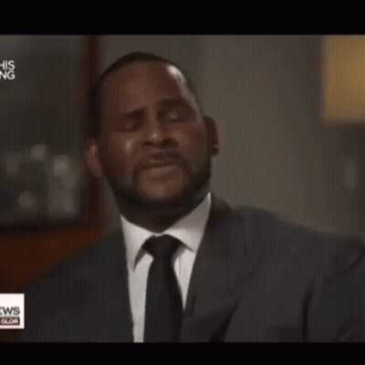 A Man In A Suit And Tie Is Crying In Front Of A News Anchor GIF