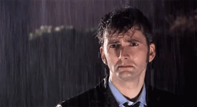 A Man In A Suit And Tie Is Crying In The Rain GIF