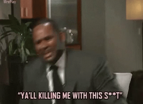 A Man In A Suit And Tie Is Dancing In A Kitchen . GIF