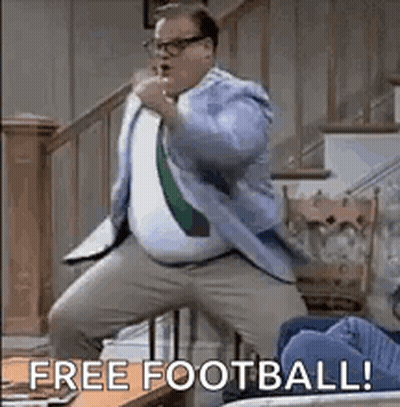 A Man In A Suit And Tie Is Dancing In A Living Room With The Words `` Free Football ! '' GIF