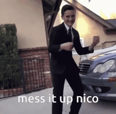 A Man In A Suit And Tie Is Dancing In Front Of A Car With The Words Mess It Up Nico Below Him GIF