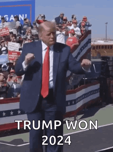 A Man In A Suit And Tie Is Dancing In Front Of A Crowd And Says Trump Won 2024 On The Bottom GIF