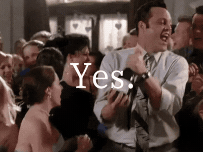 A Man In A Suit And Tie Is Dancing In Front Of A Crowd With The Word Yes Written On The Bottom GIF