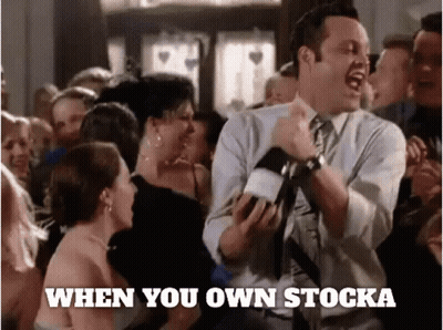 A Man In A Suit And Tie Is Dancing In Front Of A Crowd With The Words " When You Own Stocka " Written Below Him GIF