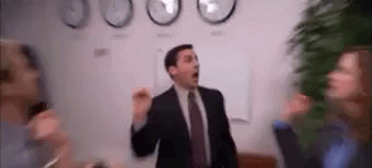 A Man In A Suit And Tie Is Dancing In Front Of A Group Of People . GIF