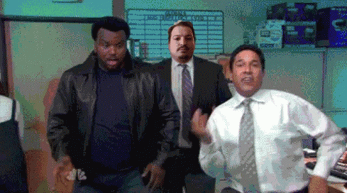 A Man In A Suit And Tie Is Dancing In Front Of A Sign That Says ' Supply Chain ' On It GIF