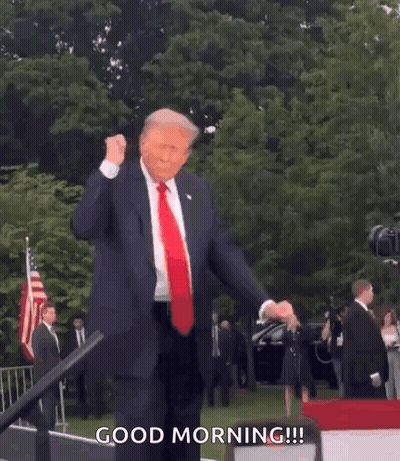 A Man In A Suit And Tie Is Dancing In Front Of An American Flag And Says Good Morning . GIF