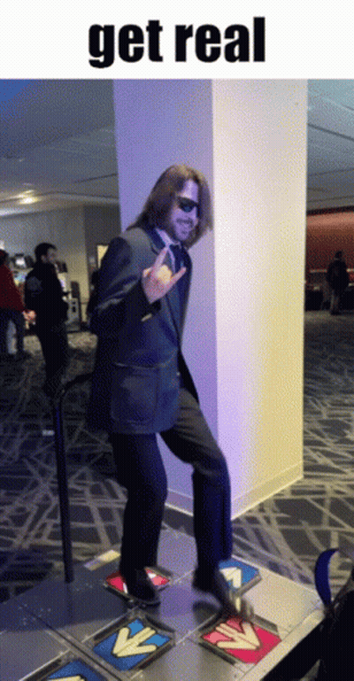A Man In A Suit And Tie Is Dancing On A Dance Floor With The Words Get Real Below Him GIF