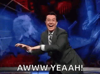 A Man In A Suit And Tie Is Dancing On A Stage And Says Awww Yeahh ! GIF