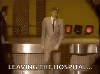 A Man In A Suit And Tie Is Dancing On A Stage With The Words Leaving The Hospital Behind Him . GIF
