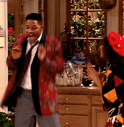 A Man In A Suit And Tie Is Dancing With A Woman In A Red Hat GIF