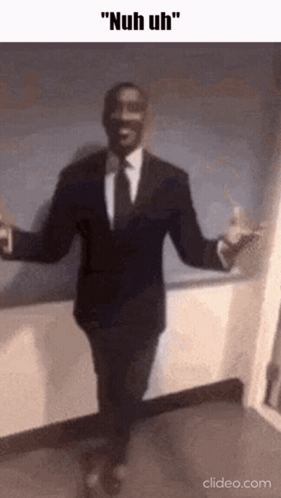 A Man In A Suit And Tie Is Dancing With His Arms Outstretched . GIF