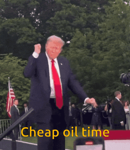 A Man In A Suit And Tie Is Dancing With The Words Cheap Oil Time Behind Him GIF