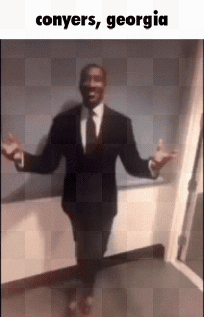 A Man In A Suit And Tie Is Dancing With The Words Conyers Georgia Written Below Him GIF