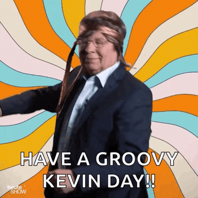 A Man In A Suit And Tie Is Dancing With The Words Have A Groovy Kevin Day Below Him GIF
