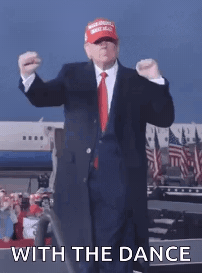 A Man In A Suit And Tie Is Dancing With The Words With The Dance Behind Him GIF