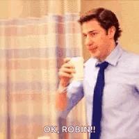 A Man In A Suit And Tie Is Drinking A Cup Of Coffee And Saying `` Ok , Robin ! '' GIF
