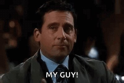 A Man In A Suit And Tie Is Drinking A Martini And Saying `` My Guy ! '' GIF