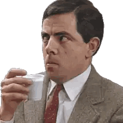 A Man In A Suit And Tie Is Drinking From A White Cup Sticker