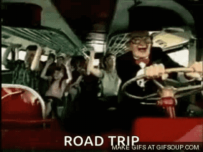 A Man In A Suit And Tie Is Driving A Bus With A Crowd Of People . GIF