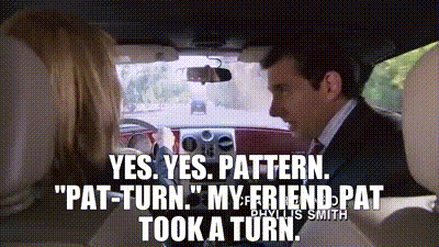 A Man In A Suit And Tie Is Driving A Car And Talking To A Woman . GIF