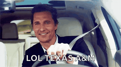 A Man In A Suit And Tie Is Driving A Car With The Words Lol Texas A & M Above Him GIF