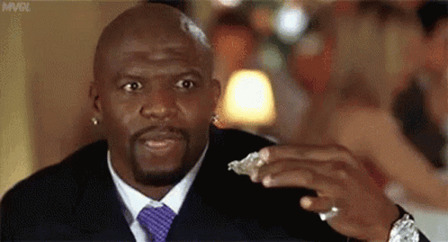 A Man In A Suit And Tie Is Eating A Piece Of Oysters . GIF