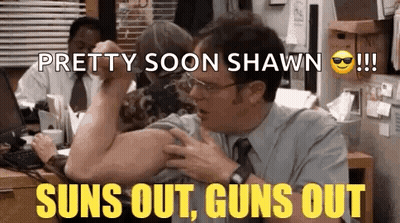 A Man In A Suit And Tie Is Flexing His Muscles In An Office While A Woman Looks On . GIF