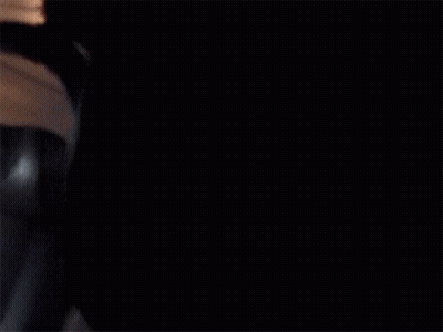 A Man In A Suit And Tie Is Flying Through The Air On An Airplane GIF
