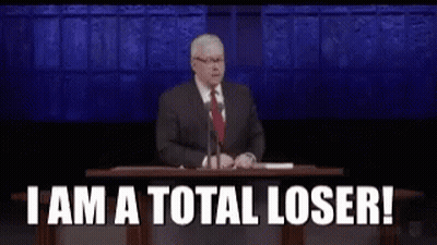 A Man In A Suit And Tie Is Giving A Speech At A Podium And Saying `` I Am A Total Loser '' GIF