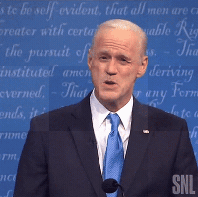 A Man In A Suit And Tie Is Giving A Speech At A Snl Show GIF