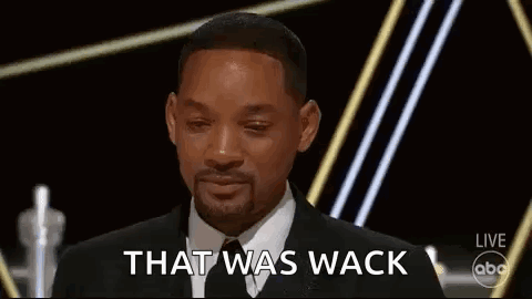 A Man In A Suit And Tie Is Giving A Speech At An Awards Ceremony . GIF