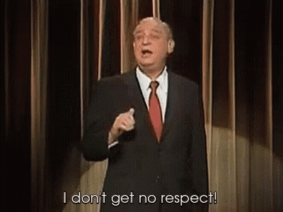 A Man In A Suit And Tie Is Giving A Speech On A Stage And Saying `` I Don T Get No Respect '' GIF