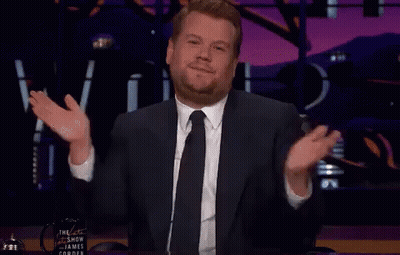 A Man In A Suit And Tie Is Giving A Thanks Gesture GIF