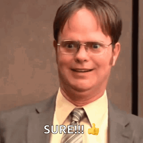 A Man In A Suit And Tie Is Giving A Thumbs Up And Says Sure GIF