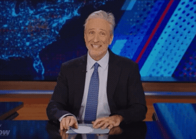 A Man In A Suit And Tie Is Giving A Thumbs Up Sign GIF
