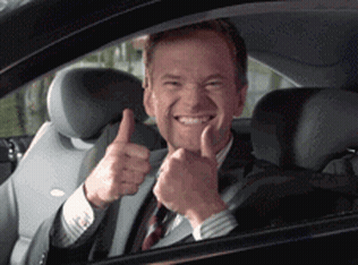 A Man In A Suit And Tie Is Giving A Thumbs Up Sign GIF