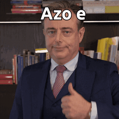 A Man In A Suit And Tie Is Giving A Thumbs Up With Azo E Written Above Him GIF