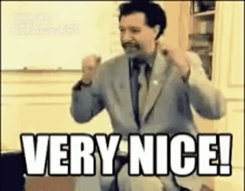 A Man In A Suit And Tie Is Giving A Very Nice ! GIF