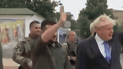 A Man In A Suit And Tie Is Giving The Middle Finger To Another Man GIF
